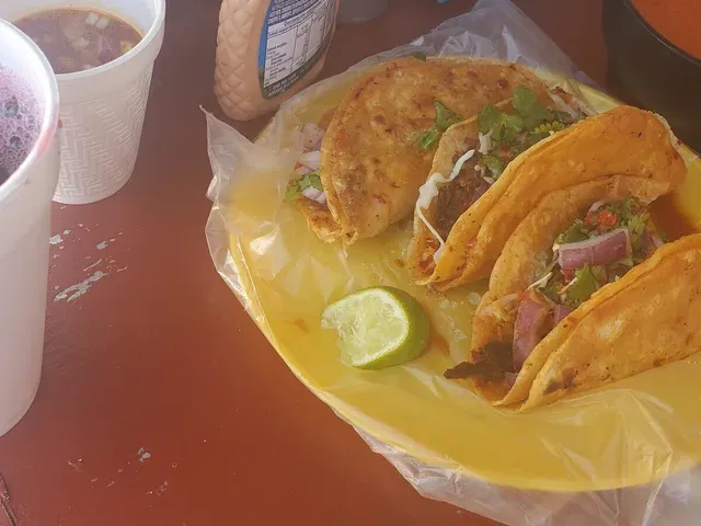 Birria tacos with lime and consomé